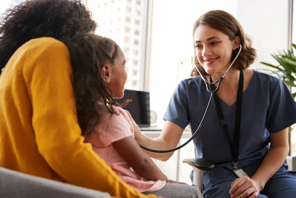 family pediatrician smiling with kid