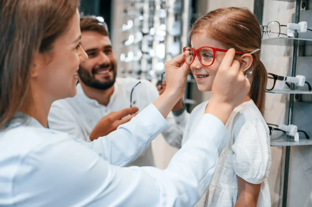 kid trying on glasses